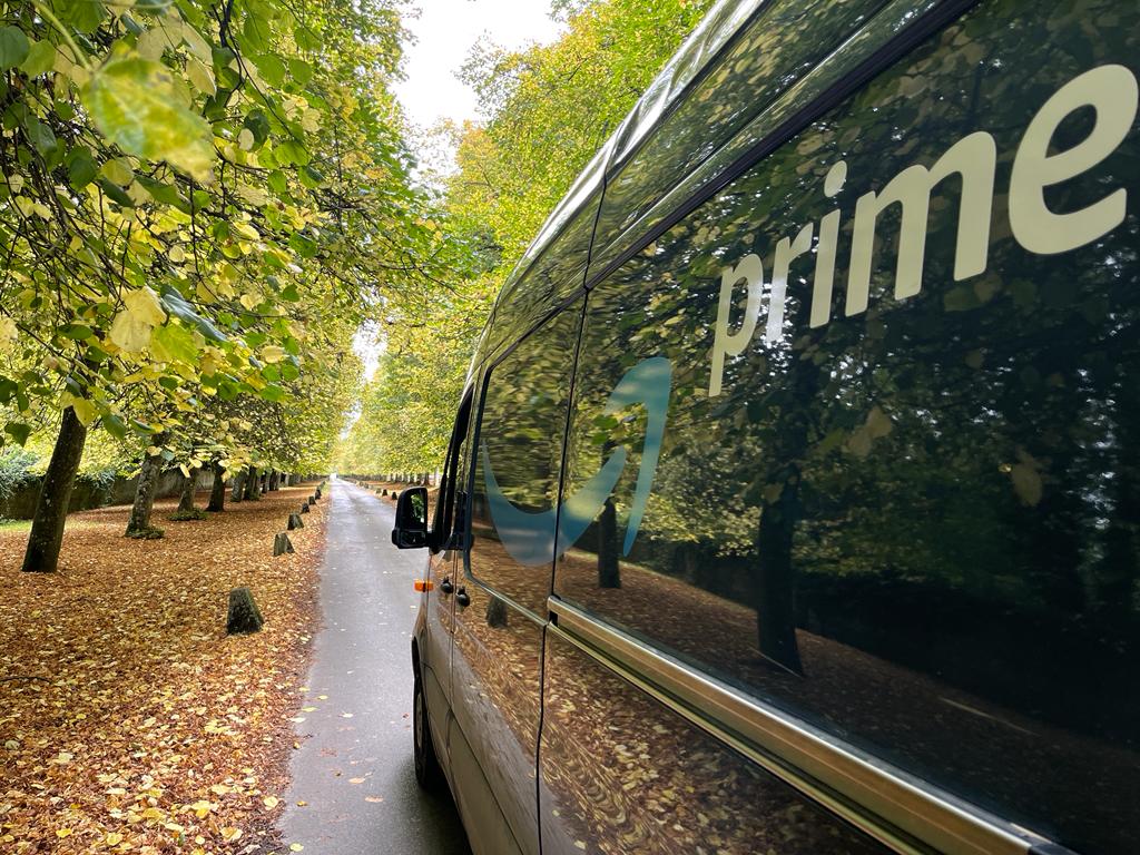Delivery van on tree-lined road