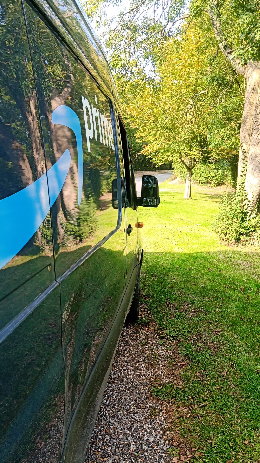 Side of delivery van on a rural road